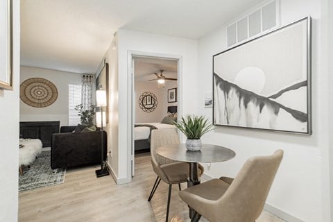 a living room with a table and chairs